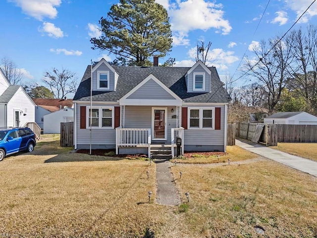 view of front of home with roof with shingles, crawl space, covered porch, fence, and a front lawn