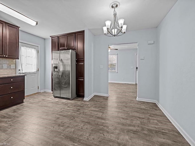 kitchen with plenty of natural light, dark brown cabinets, light wood-type flooring, and stainless steel fridge with ice dispenser