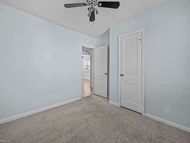 unfurnished bedroom with carpet, baseboards, and a ceiling fan