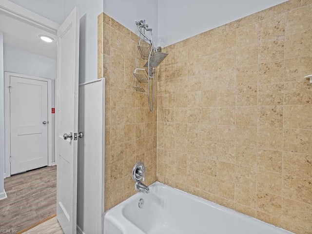 full bath with wood finished floors and shower / tub combination