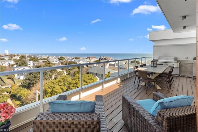 balcony featuring a water view and a grill