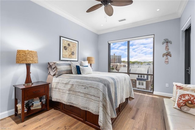 bedroom with ornamental molding, visible vents, light wood-style flooring, and baseboards