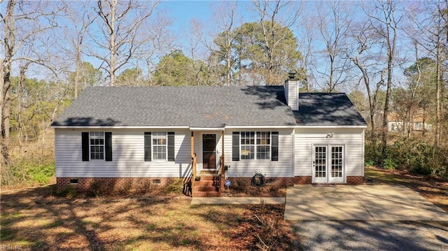 cape cod-style house with crawl space, roof with shingles, and a chimney