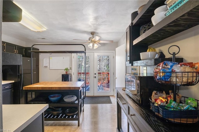 kitchen with french doors, open shelves, wooden counters, freestanding refrigerator, and ceiling fan