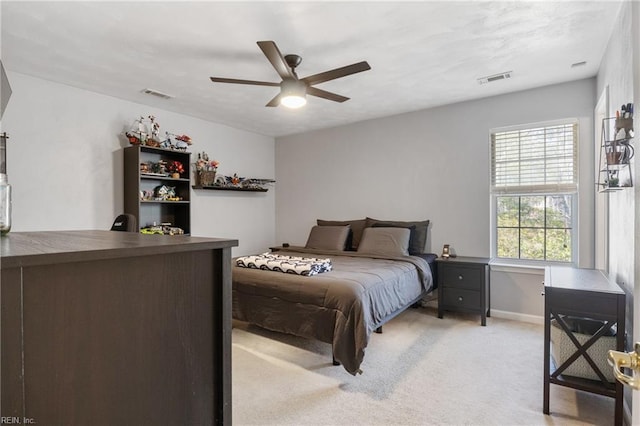 bedroom featuring visible vents, ceiling fan, light carpet, and baseboards