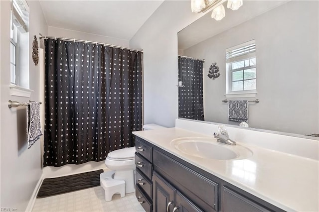 bathroom featuring toilet, a shower with curtain, vanity, and tile patterned floors