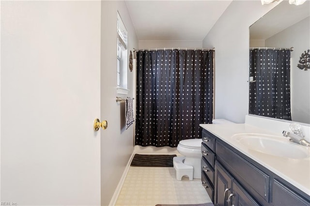 full bathroom with toilet, tile patterned floors, baseboards, and vanity