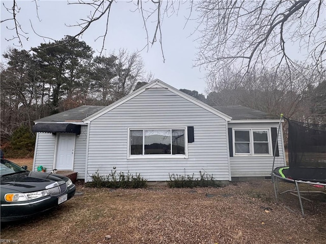 view of front of home with a trampoline and crawl space