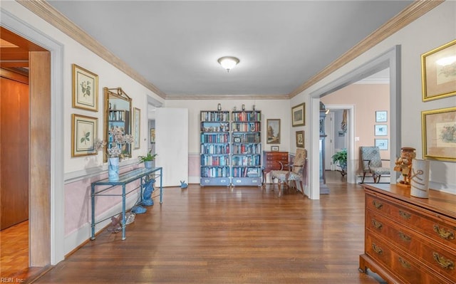 sitting room featuring ornamental molding and wood finished floors