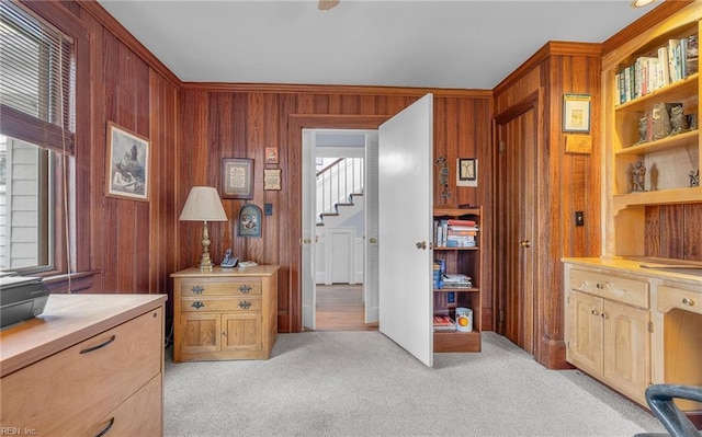 office featuring light carpet and wood walls