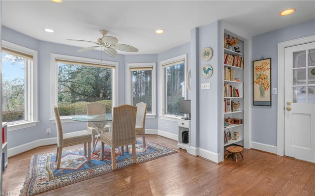 sunroom / solarium featuring a ceiling fan