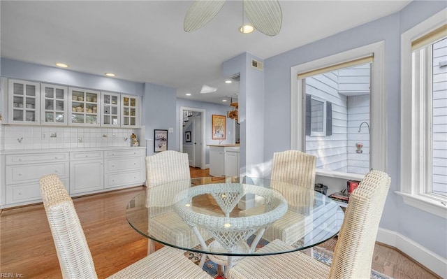 dining space featuring light wood-style flooring, visible vents, baseboards, and recessed lighting