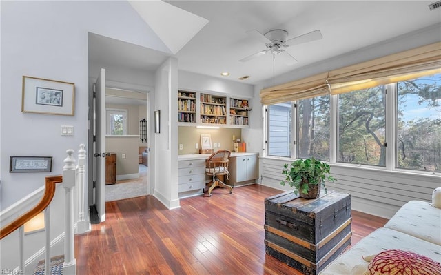 interior space with a healthy amount of sunlight, built in study area, and wood finished floors