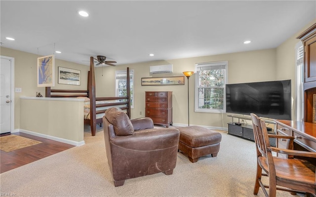 carpeted living room featuring plenty of natural light, a wall mounted air conditioner, baseboards, and recessed lighting