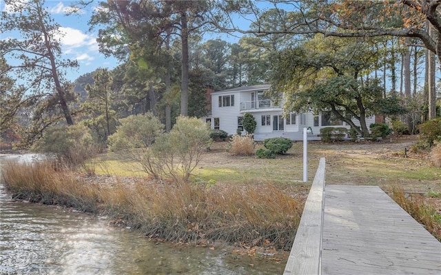 dock area featuring a water view and a balcony