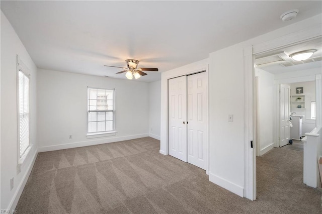 unfurnished bedroom with ceiling fan, carpet floors, a closet, and baseboards