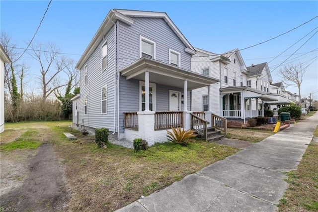 view of front facade featuring driveway and covered porch