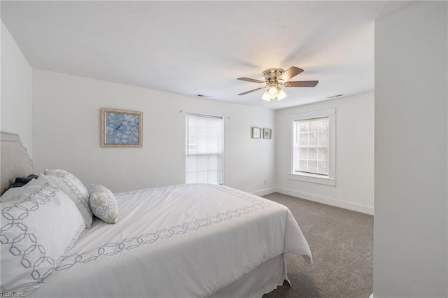 bedroom with carpet floors, visible vents, baseboards, and a ceiling fan