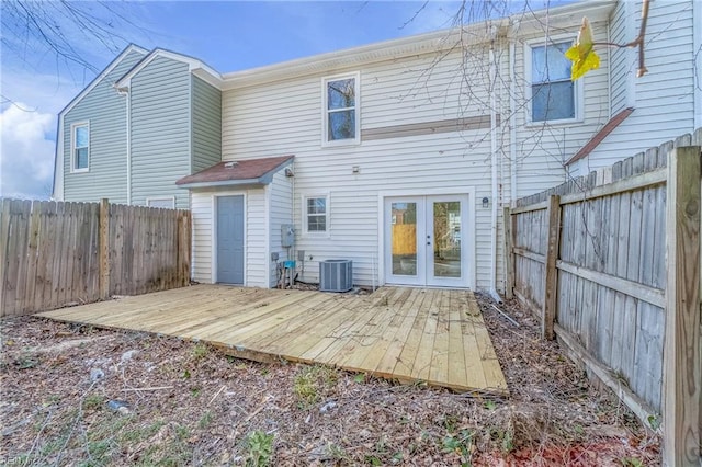 rear view of property featuring central air condition unit, a fenced backyard, french doors, and a wooden deck