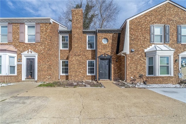 multi unit property with brick siding and a chimney