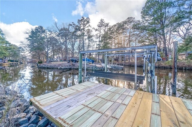 dock area with a water view and boat lift