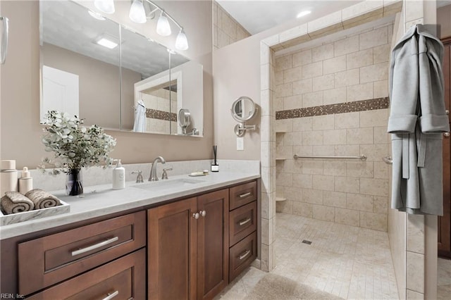 bathroom featuring a walk in shower and vanity