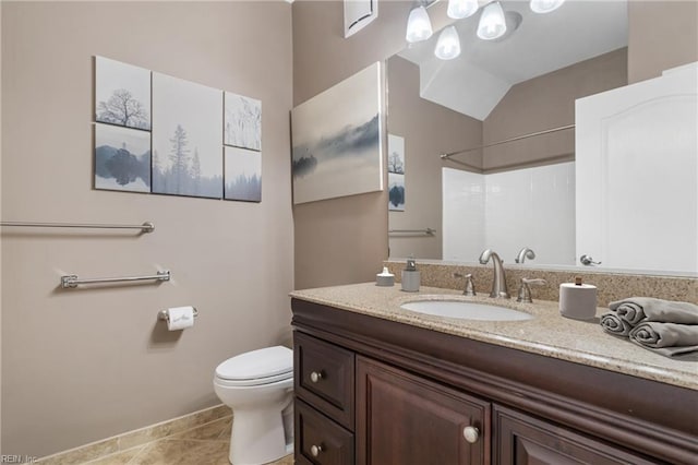 bathroom featuring toilet, tile patterned floors, a shower, and vanity