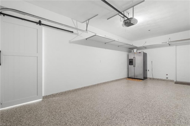 garage featuring a garage door opener and stainless steel fridge with ice dispenser