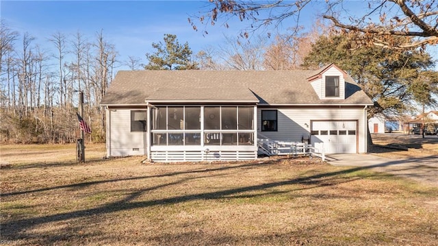 view of front of home featuring a sunroom, crawl space, a front lawn, and an attached garage