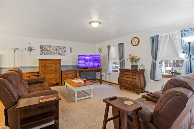 carpeted living area with baseboards