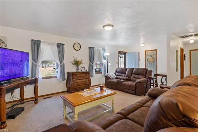 living area featuring baseboards, visible vents, and carpet flooring