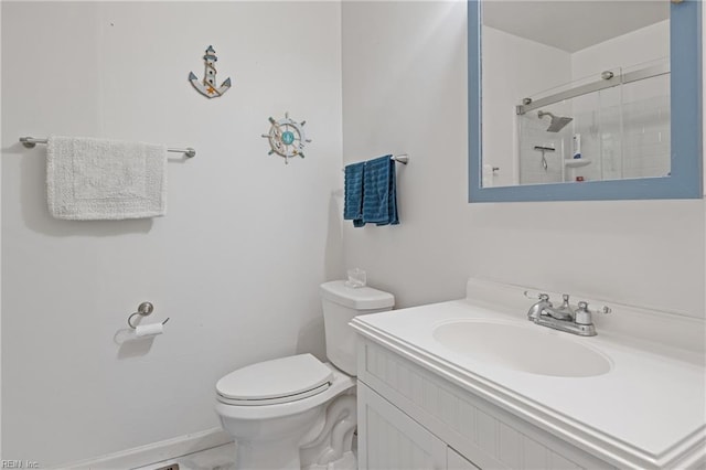 bathroom with vanity, an enclosed shower, and toilet