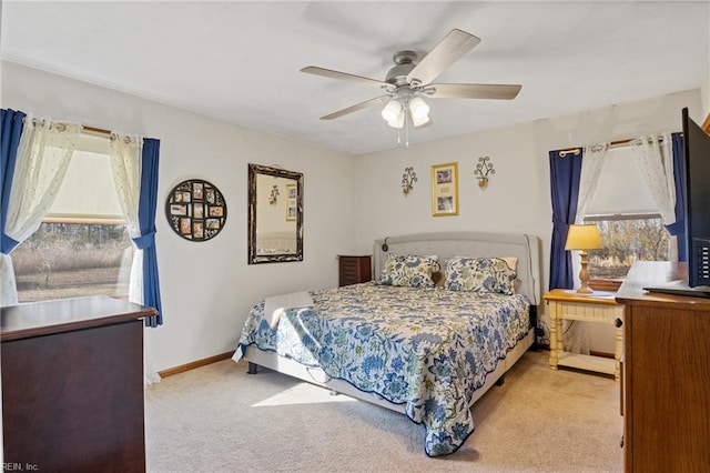 carpeted bedroom featuring ceiling fan and baseboards