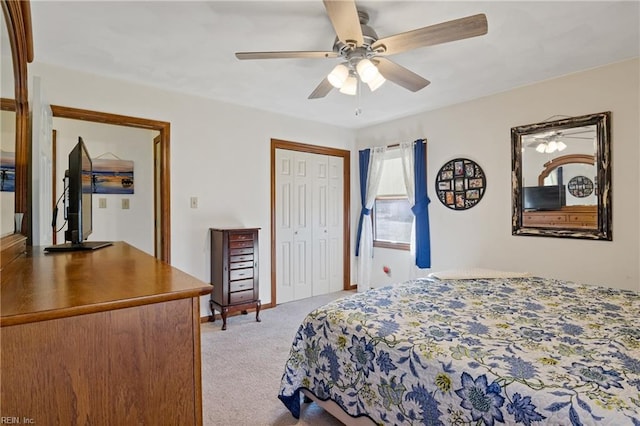 bedroom with light carpet, ceiling fan, and a closet