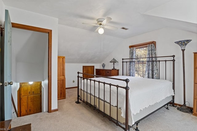 bedroom with carpet floors, lofted ceiling, visible vents, and ceiling fan