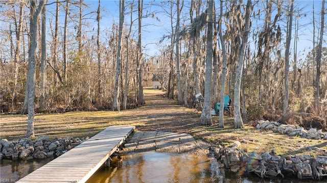 view of dock featuring a wooded view