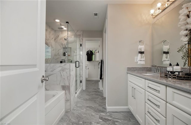 bathroom featuring marble finish floor, a stall shower, vanity, baseboards, and a bath