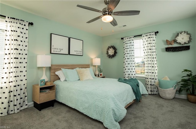 bedroom featuring carpet floors, visible vents, ceiling fan, and baseboards