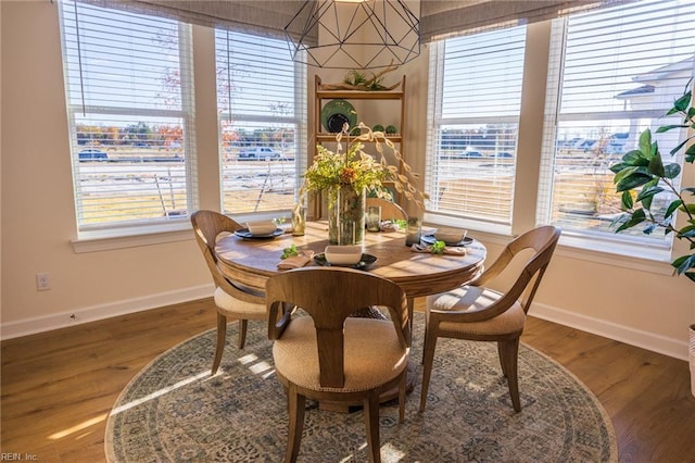 dining area featuring baseboards and wood finished floors