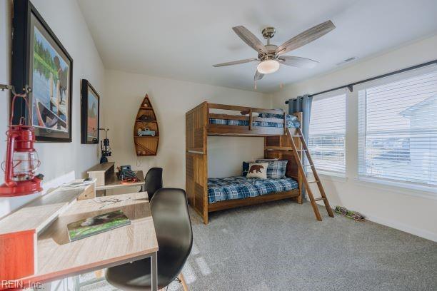 carpeted bedroom featuring baseboards