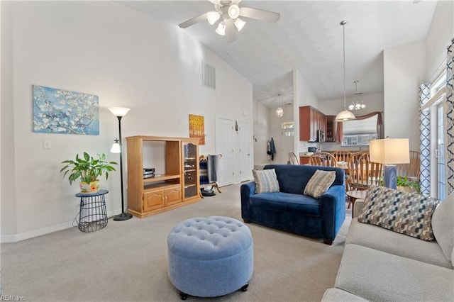 living area featuring visible vents, baseboards, ceiling fan, carpet, and high vaulted ceiling