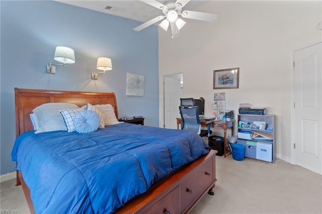 bedroom featuring light carpet, a towering ceiling, visible vents, and baseboards