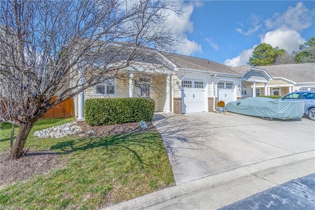 view of front of home featuring a garage, a front yard, concrete driveway, and brick siding