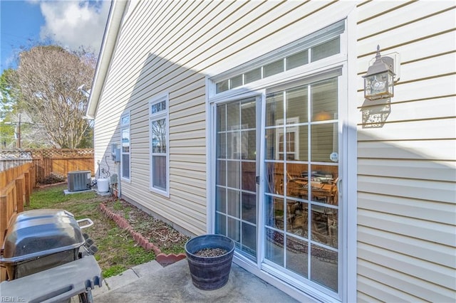 exterior space featuring fence, cooling unit, and a grill