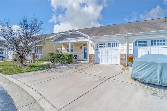 view of front facade featuring driveway, brick siding, an attached garage, and a shingled roof