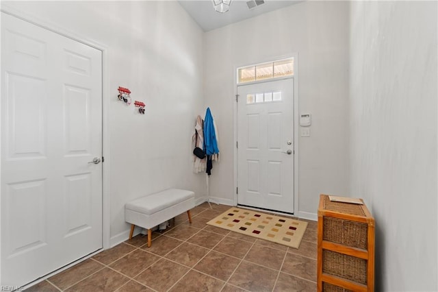 entryway featuring visible vents, dark tile patterned floors, and baseboards