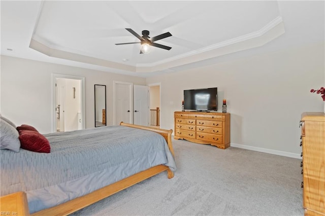 carpeted bedroom with ceiling fan, crown molding, a raised ceiling, and baseboards