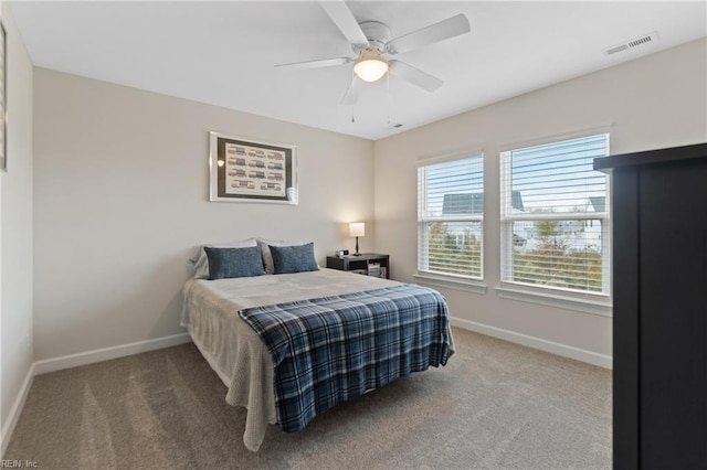 bedroom with carpet, visible vents, ceiling fan, and baseboards