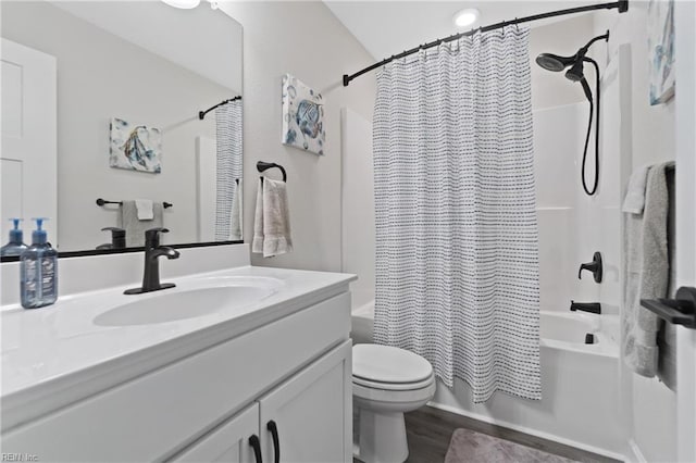 bathroom with wood finished floors, shower / bath combo, vanity, and toilet