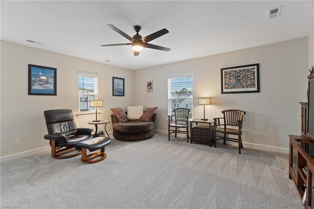 sitting room featuring visible vents, a wealth of natural light, and carpet flooring